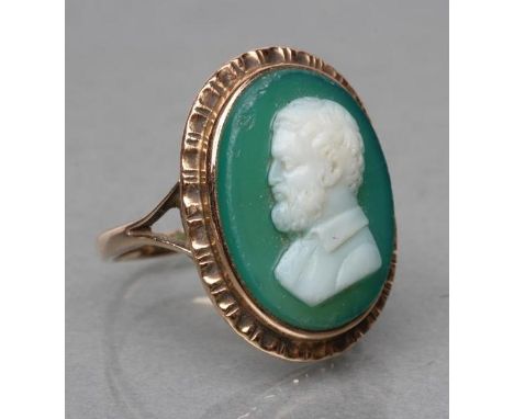 A GREEN AND WHITE GLASS CAMEO RING, the oval panel cut with the head and shoulders portrait of a bearded man, collet set to a