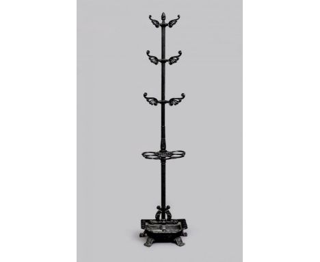 A REGENCY CAST IRON COAT AND STICK STAND, early 19th century, the reeded stem with pineapple finial issuing three pairs of sc