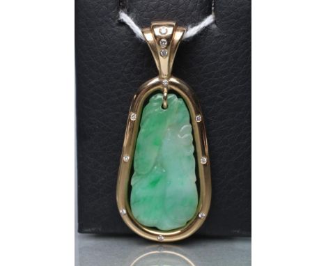 A JADE PENDANT, the tear shaped panel carved with stylised fruit pierced to hang from a cylindrical frame stamped 14k*, set w