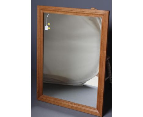 A COLIN ALMACK OAK FRAMED WALL MIRROR, the moulded oblong frame with carved beaver trademark in high relief, 32" x 42" (Est. 