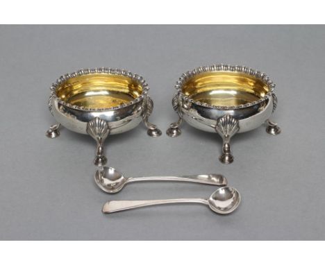 A PAIR OF EARLY GEORGE III SALTS, maker R & D Hennell, London 1767, of oval form with everted gadrooned rims raised upon four