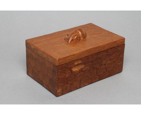 A ROBERT THOMPSON ADZED OAK TRINKET BOX of oblong form, carved mouse trademark in high relief on detachable lid, 7" wide (Est