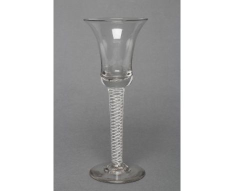 A WINE GLASS, mid 18th century, the bell bowl on a mixed twist stem with central multi-ply air twist spiral surrounded by whi