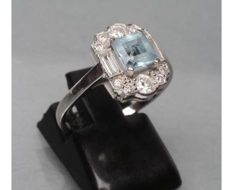 AN ART DECO DRESS RING, the square cut aquamarine claw set to baguette diamond set shoulders and ten graduated point set diam