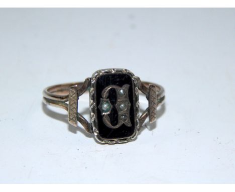 A Victorian gold, black and enamel and seed pearl set mourning ring, the rectangular setting marked with a letter B, size R, 