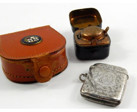 A Victorian silver vesta case, foliate engraved with reserve monogrammed shield, Birmingham 1898, a red morocco cased brass t