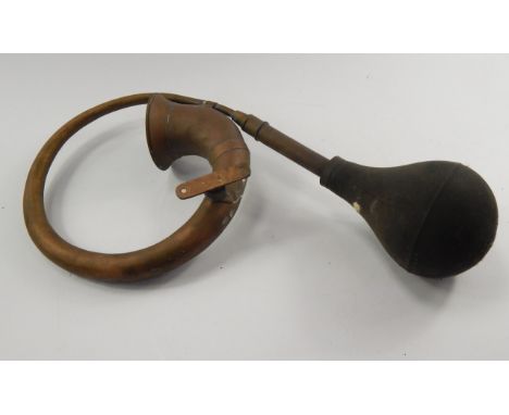 A vintage brass car horn.