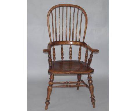 A 19thC oak and elm Windsor chair, with plain and turned spindles, raised on turned legs united by a ladder frame stretcher.