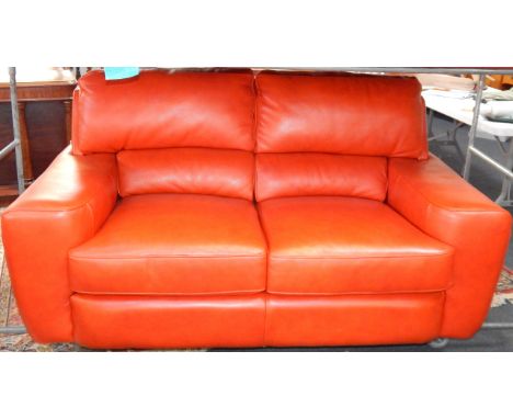 A red hide two seater sofa, 165cm long, 93cm deep, 87cm high.
