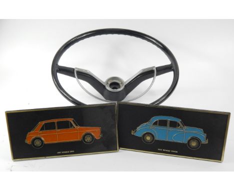 A classic Morris car steering wheel and two Unipart plastic easel plaques of Morris cars (3)