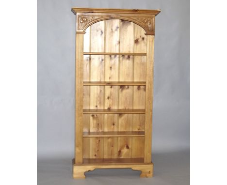 A pine open bookcase, of five shelves raised on bracket feet,, 94cm long, 29.5cm deep, 183.5cm high.