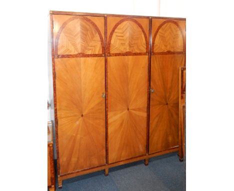 An Art Deco walnut, burr walnut and inlaid bedroom suite, comprising; a compactum triple wardrobe with three doors enclosing 