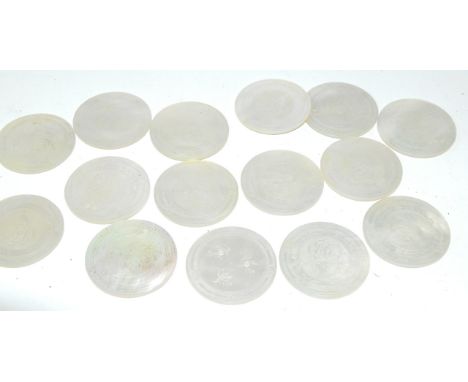 A set of Chinese mother of pearl gaming counters, 19thC, crest and monogram engraved, verso floral sprigs, each 3.5cm diamete