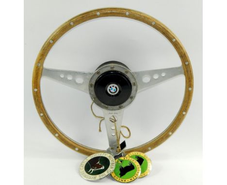 A Moto-Lita vintage steering wheel, with BMW boss, and enamel bar badges for Ayreshire Cattle Society, Aberdeen Angus Society