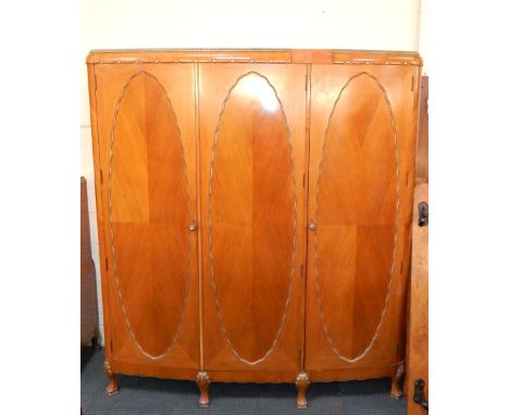 An Art Deco walnut, mahogany and faux metal trimmed bedroom suite, comprising; a dressing table with a swing frame triptych r