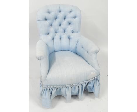 A Victorian mahogany spoon back armchair, upholstered in turquoise button back fabric, raised on turned legs on castors.