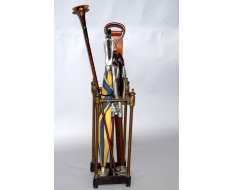 A brass square framed four section stick stand, with a cast iron base, 59cm high, together with a copper hunting horn and fou