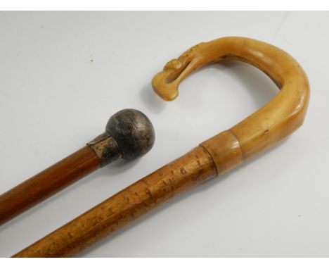 A malacca walking cane, with a circular silver knop, Birmingham 1923, 90.5cm long, together with a walking stick with a carve