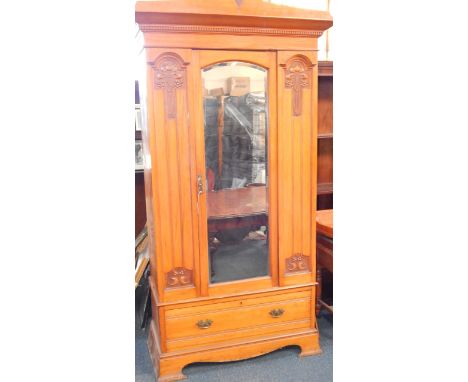 A Victorian Art Nouveau satin walnut bedroom suite, comprising; double wardrobe with an outswept pediment above a mirrored do
