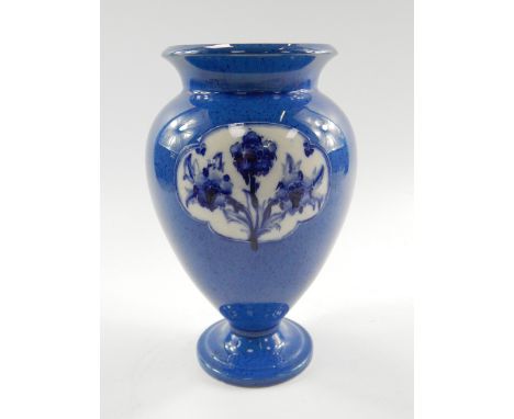 A William Moorcroft, late Florian ware vase, of baluster form reserve decorated with Forget-Me-Nots against a powder blue gro