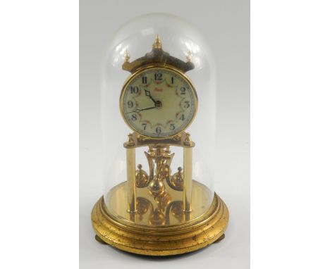 A Kundo brass torsion clock, enamel dial decorated with floral swags, bearing Arabic numerals, 400 day movement, on a circula