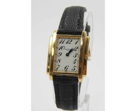 A 18ct gold Patek Philippe lady's wristwatch, with white enamel dial and gold surround, on black leather strap.