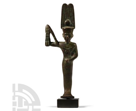 Late Period, 664-332 B.C. Modelled in the round as a votive ithyphallic figure wearing a double-plumed crown with a sun disc,