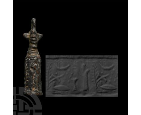 900-700 B.C. Cylinder with attached cord and bead handle; accompanied by a copy of an old scholarly note, typed and signed by