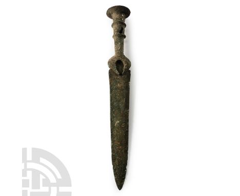 Late 2nd-early 1st millennium B.C. The blade with shallow midrib, hilt cast with two horizontal grooves and crescentic guard.