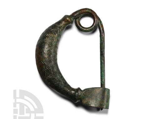 10th-8th century B.C. A 'sanguisuga' (leech) fibula with hollow, vertically ribbed bow; integral coiled spring and ellipsoid 