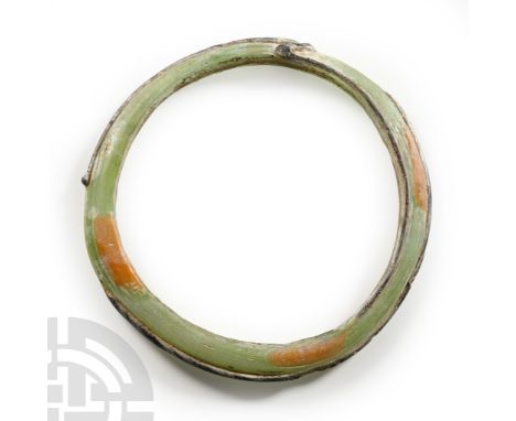 2nd century B.C.-1st century A.D. D-section bangle in aqua glass with applied dark red trails to the outer face. Cf. Kunstmus