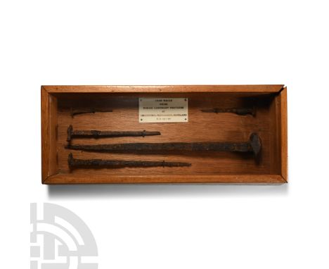 Circa 83-87 A.D. Group of five iron clout-nails permanently mounted in a wooden display case with sloping sides and sliding g