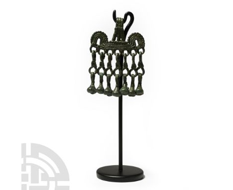 8th-10th century A.D. Pendant with ribbed lop transverse bar with arched finials, row of loops below with bell-shaped dangles