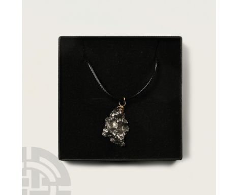 Fell 6000-5000 years B.P. Comprising a section of nickel-iron meteorite (IAB) set with a suspension loop and suspended from a