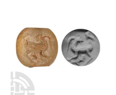 Aegean, 9th-8th century B.C. Lentoid in section with intaglio goat looking backwards towards a bird in flight; supplied with 