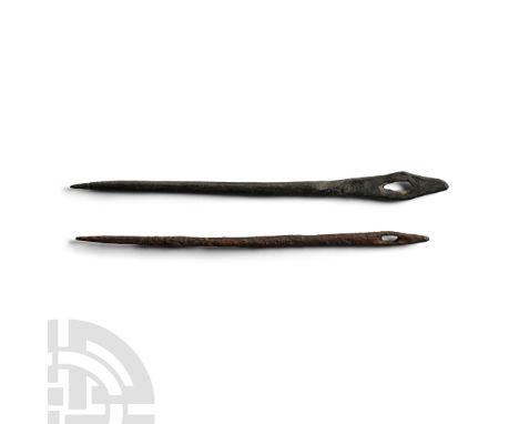 1st-4th century A.D. Bronze needle with flattened head and punched slit eye; similar in iron; with old identification label '