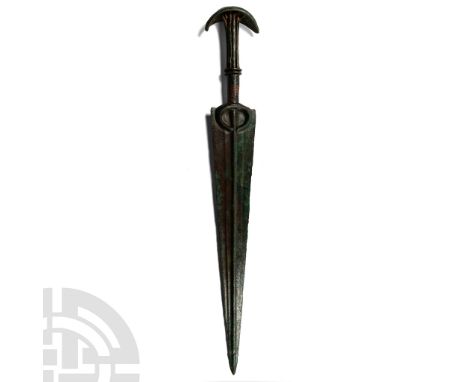 14th-10th century B.C. Formed with a slender triangular blade, raised midrib with flat upper face, penannular guard and scoop