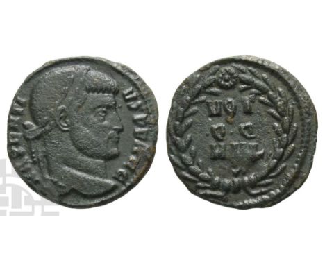 Maxentius AE Quarter Nummus.. AD 307-312. Rome mint; struck AD 310-312. MAXENTI-VS P F AVG, laureate head to right / VOT • Q 