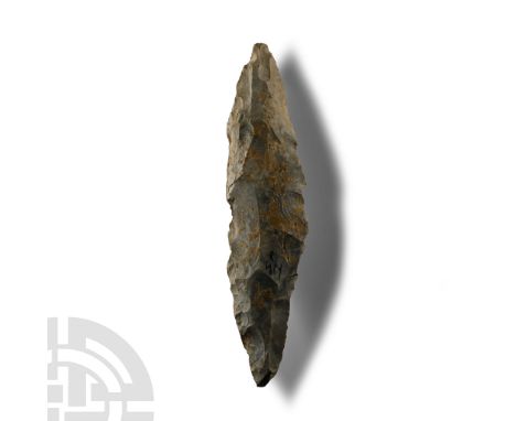 Neolithic Period, circa 6000 B.P. Triangular in section with narrow point to each end, grey-white silicious material with som
