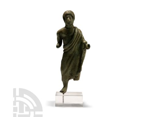 Late 5th century B.C. Bronze figure of a youth in contrapposto stance, wrapped in a long mantle revealing his right shoulder 