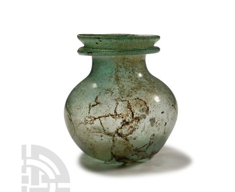 3rd-4th century A.D. With dimpled base, squat globular body with shallow dimple above the base, broad neck with gusseted rim.