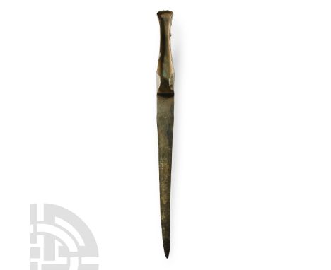 12th century B.C. With lentoid-section blade, tongue-shaped in plan, with integral tapering hilt with flared finial, lateral 