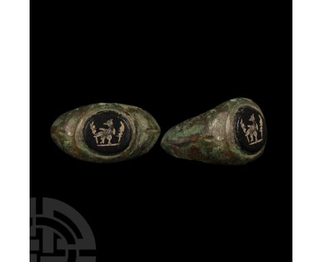 2nd-3rd century A.D. Sturdy hoop, broad plaque with inset glass stud with perching eagle flanked by military standards. Cf. R
