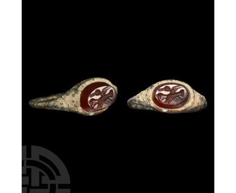 2nd-3rd century A.D. Slender hoop and ellipsoid bezel with inset carnelian intaglio clasped-hands motif. Cf. Chadour, A.B., R