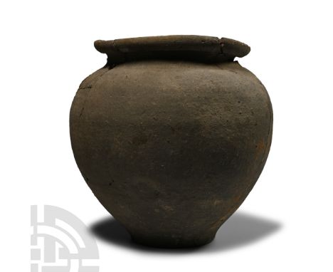 2nd-3rd century A.D. Ovate in profile with disc foot, deep shoulder and flared rim to the mouth; containing fragments of anci