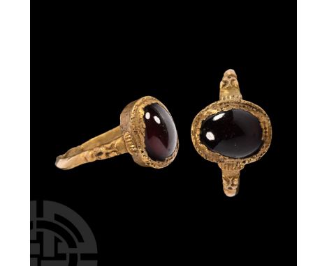 15th century A.D. Comprising a slender D-section hoop with balustered shoulders, ellipsoid cell with garnet cabochon; restore