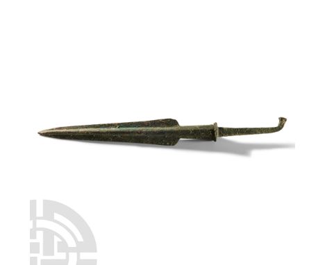 1500-1000 B.C. With heavily ridged and tapered blade, short collared shaft and tapered bent tang with round stud terminal. Se