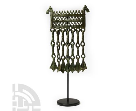 8th-10th century A.D. Horizontal lattice bands with horse-head finials above, loops below each with an articulated chain and 