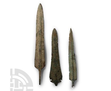25th-11th century B.C. Comprising two bronze spearheads with a short tang and flat midrib, a dagger pointed blade with short 