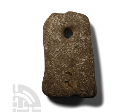 Neolithic Period, circa 6000 B.P. Tongue-shaped in profile with chamfered lower edge, circular ground hole for suspension, ab